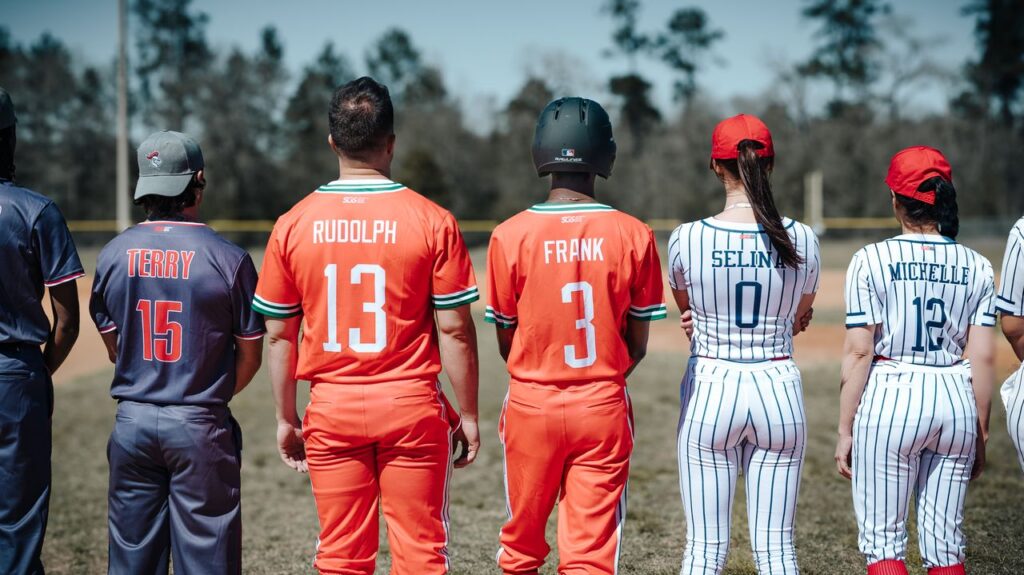 Baseball team members standing on the field in uniform