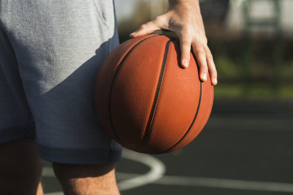 Player gripping basketball while standing on the court